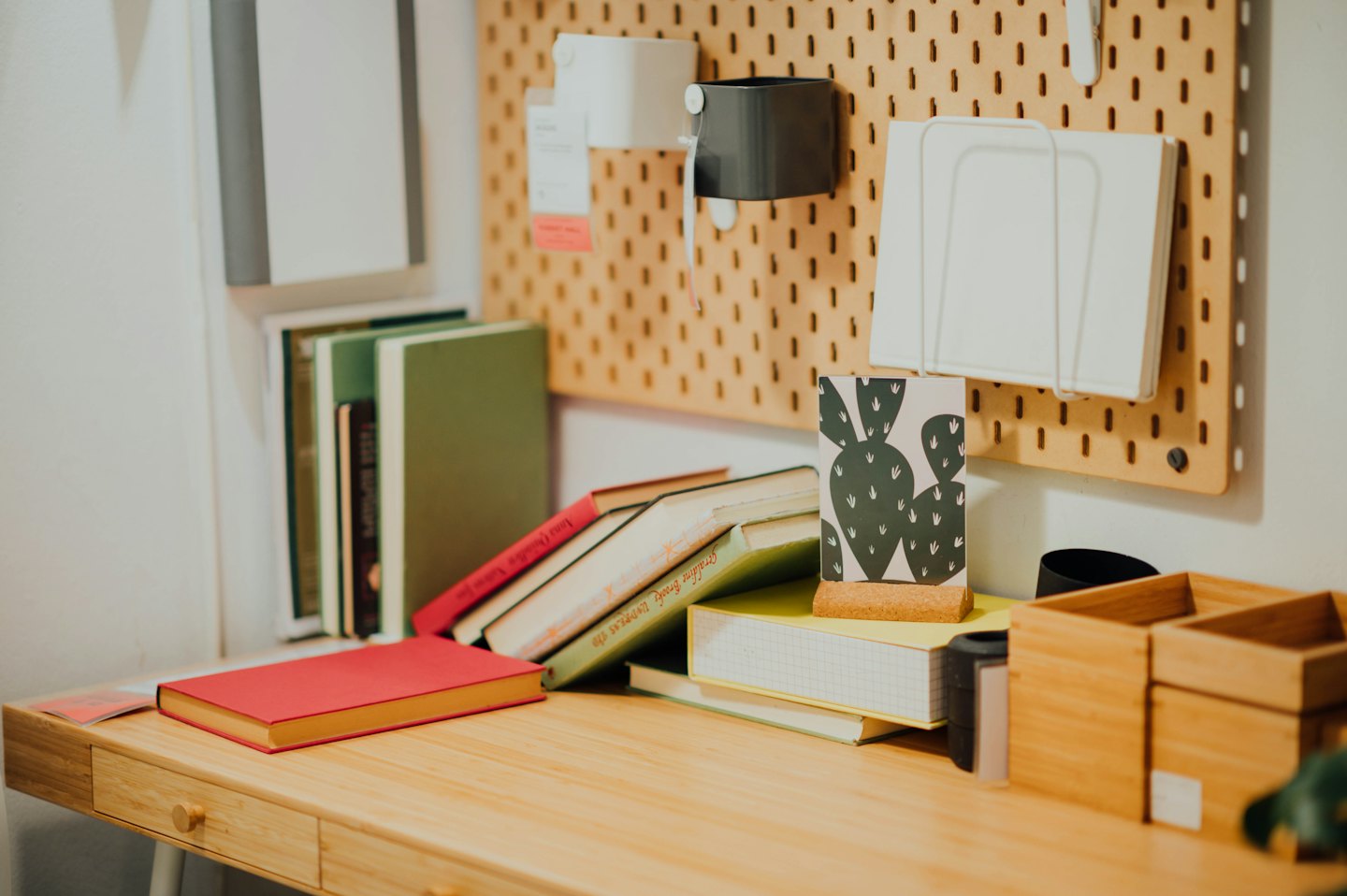Books and office organizers are arranged on a wooden desk.